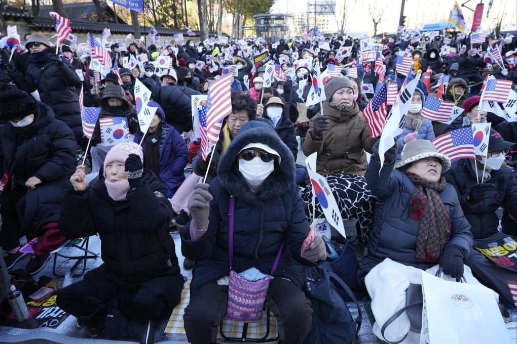 Supporters of then South Korean president Yoon Suk-yeol waving the Korean and US flags stage a rally against opposition politicians in Seoul, South Korea, on December 6 last year. Photo: AP