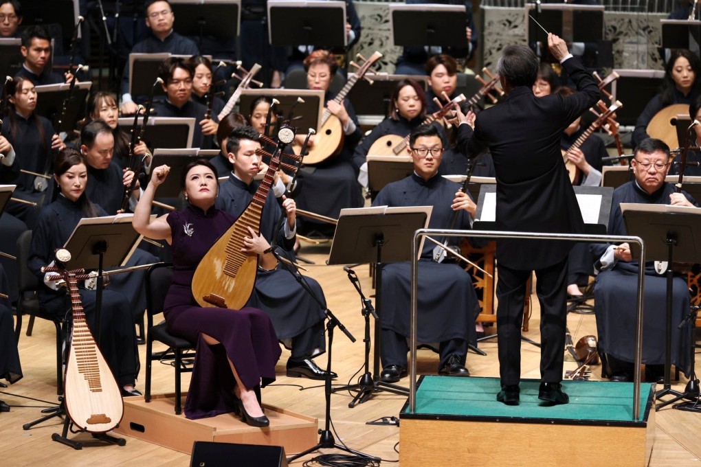 Zhang Ying (left, in armless dress), Hong Kong Chinese Orchestra’s principal pipa, performs during the orchestra’s “Silken Notes of the Pipa” concert at the Hong Kong Cultural Centre Concert Hall in September. Photo: Hong Kong Chinese Orchestra