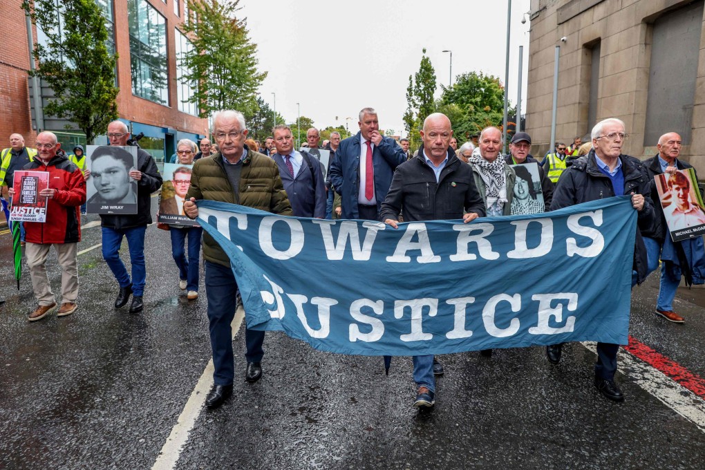 Family members and supporters of those killed on Bloody Sunday walk to Belfast Crown Court as the trial of soldier F begins, in Belfast, Northern Ireland on Monday. Photo: AFP