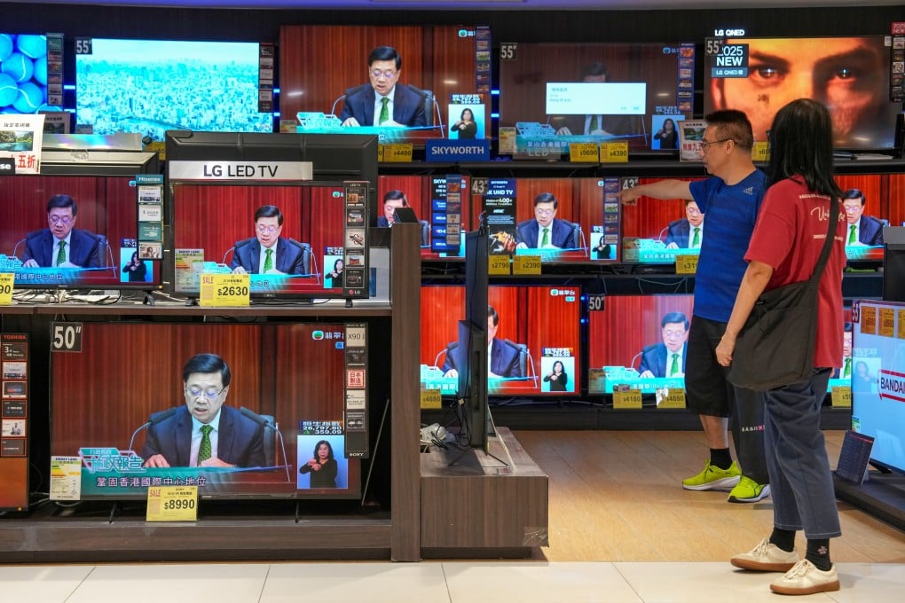 Residents watch a live broadcast of Chief Executive John Lee delivering his policy address at a department store. Photo: Jelly Tse