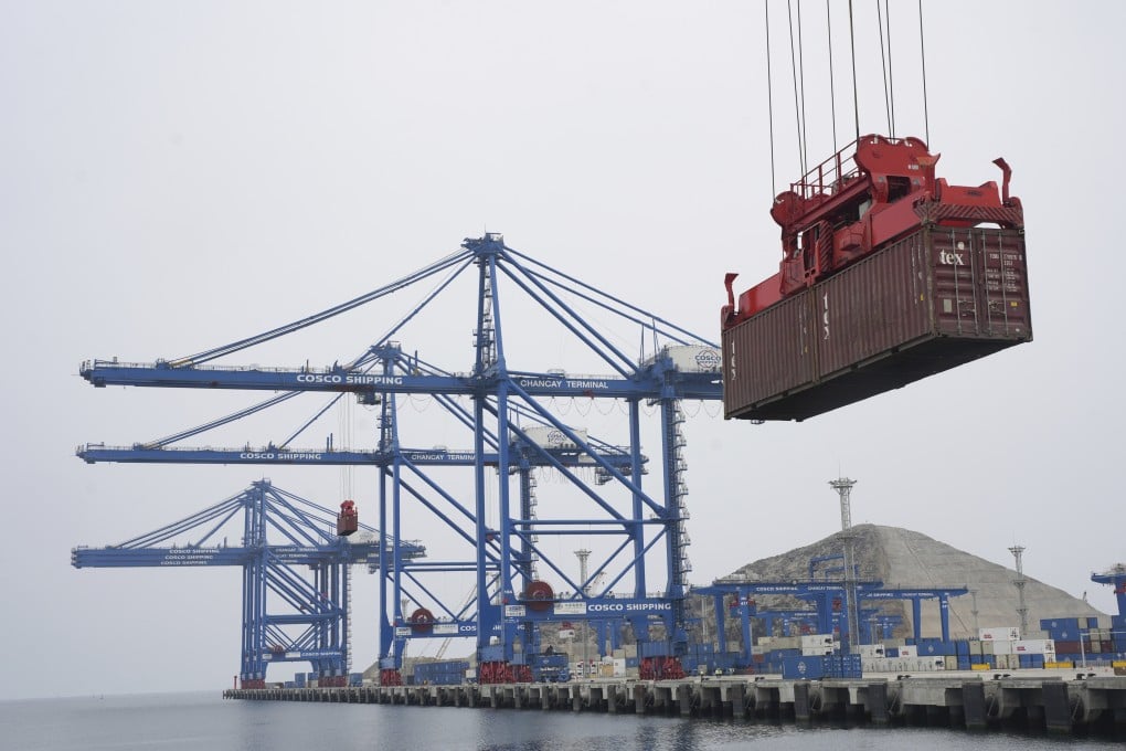 A container is lifted by a crane backdropped by the construction of the Chinese-funded mega port in Chancay, Peru, on October 29, 2024. Photo: AP