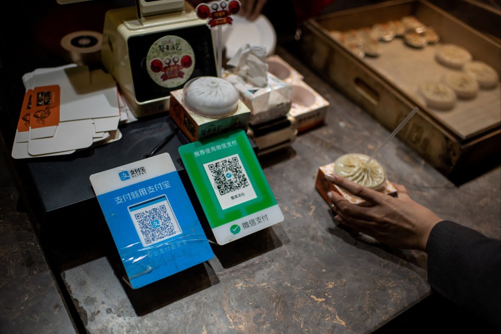 An Alipay QR code (left) and a Weixin Pay QR code displayed at a shop in Beijing. Photo: AFP
