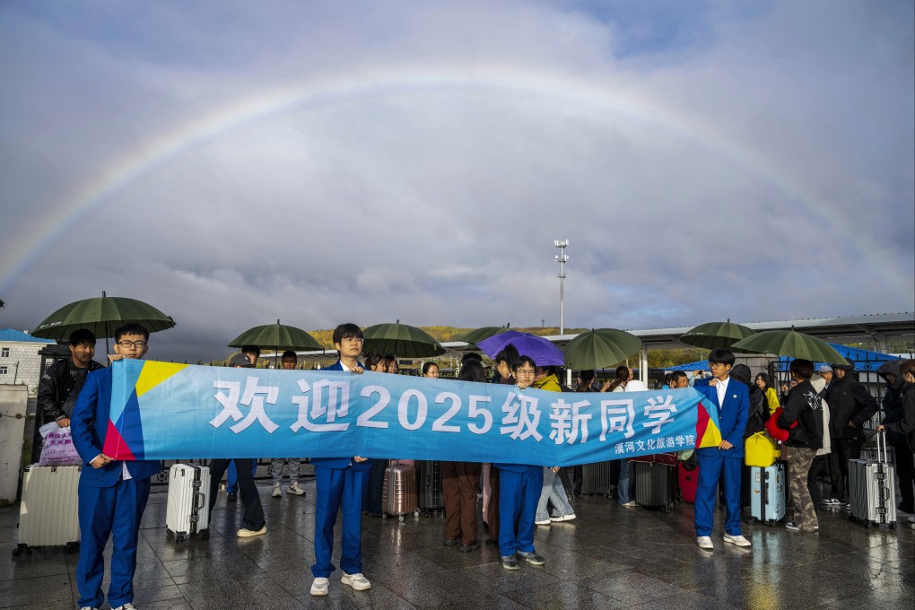 First-year students and parents are greeted by a banner from Mohe culture and tourism school as they gather at the exit of a railway station in Mohe, Heilongjiang province on September 13. Photo: Xinhua