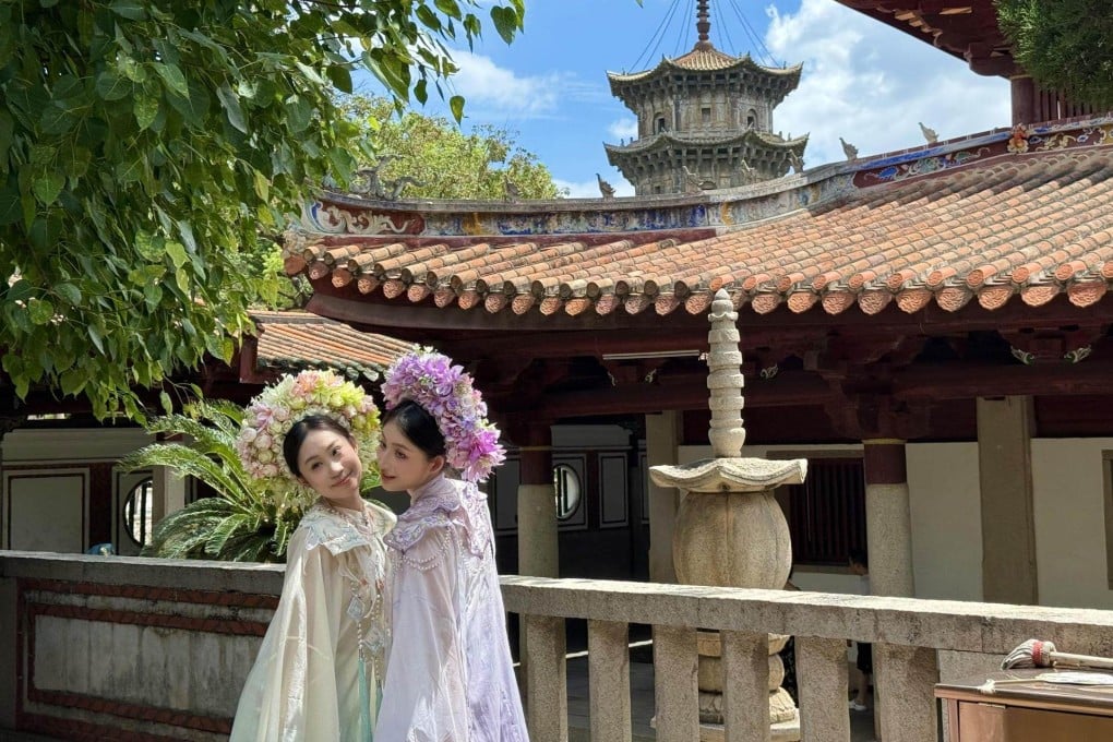 Travellers dressed in traditional garb pose at Kaiyuan Temple in Quanzhou, China. The city enchants visitors with its history and culture. Photo: The Korea Times