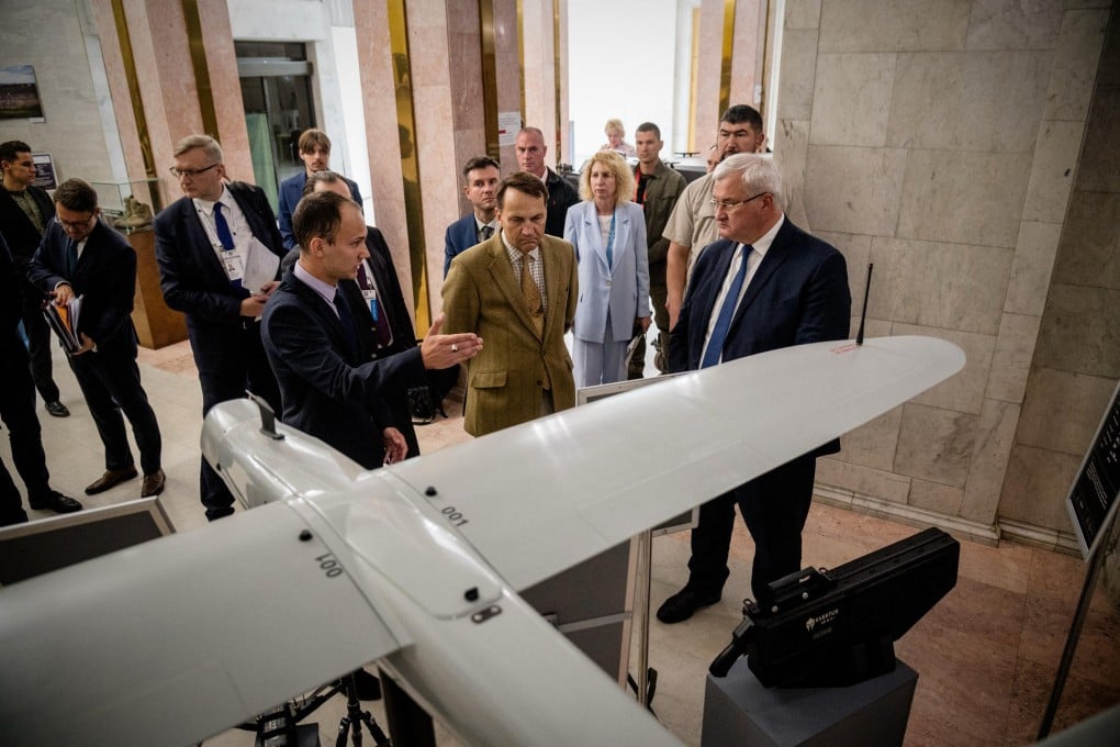 Ukraine’s Foreign Minister Andriy Sybiga (right) and his Polish counterpart
Radoslaw Sikorski (middle) look at drones as they visit an exhibition showcasing Ukrainian unmanned vehicles in Kyiv on Friday. Photo: AFP