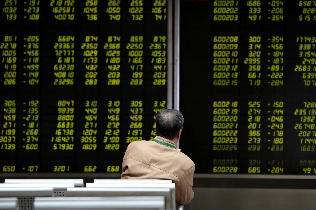 An investor watches a board showing stock information at a brokerage office in Beijing, China, on October 8, 2018. Photo: Reuters