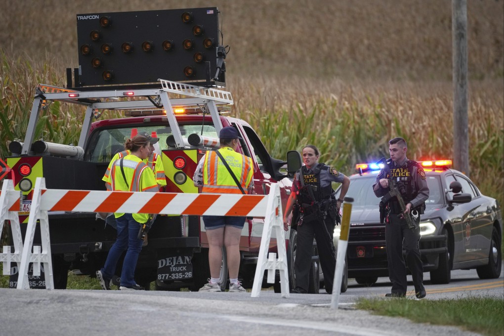 Pennsylvania state police troopers and emergency workers block a road a shooting in North Codorus on Wednesday. Photo: AP