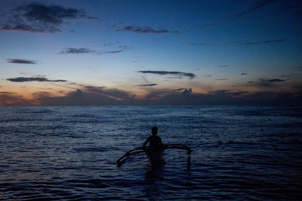A Filipino fisheman rows his boat near the disputed Scarborough Shoal in the South China Sea, Photo: Reuters