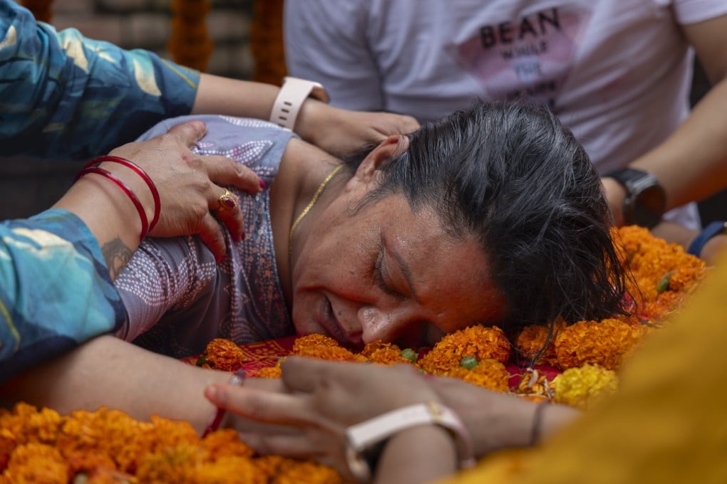 The mother of Rashik Khadiwoda, who was killed during the Gen Z protest, pays her last respects to his body in Kathmandu, Nepal, on Tuesday. Photo: EPA