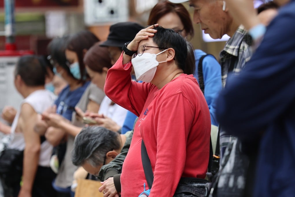 A woman wears a mask at a bus stop in Mong Kok on March 27. Photo: Jelly Tse