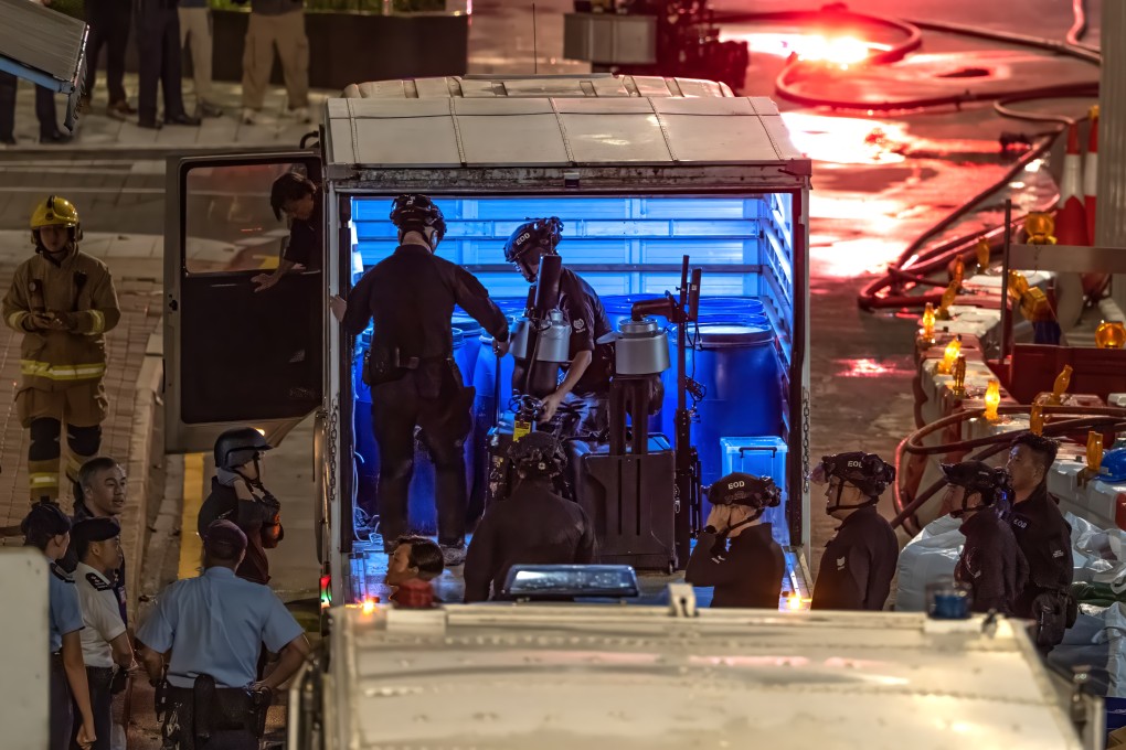 Officers from the bomb disposal team get their gear ready on Pan Hoi Street. Photo: Robert Ng