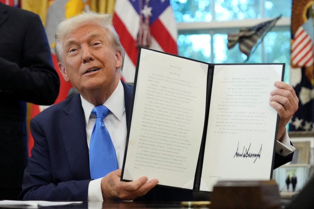 US President Donald Trump displays a signed executive order on the new gold card visa at the White House on Friday. Photo: Reuters