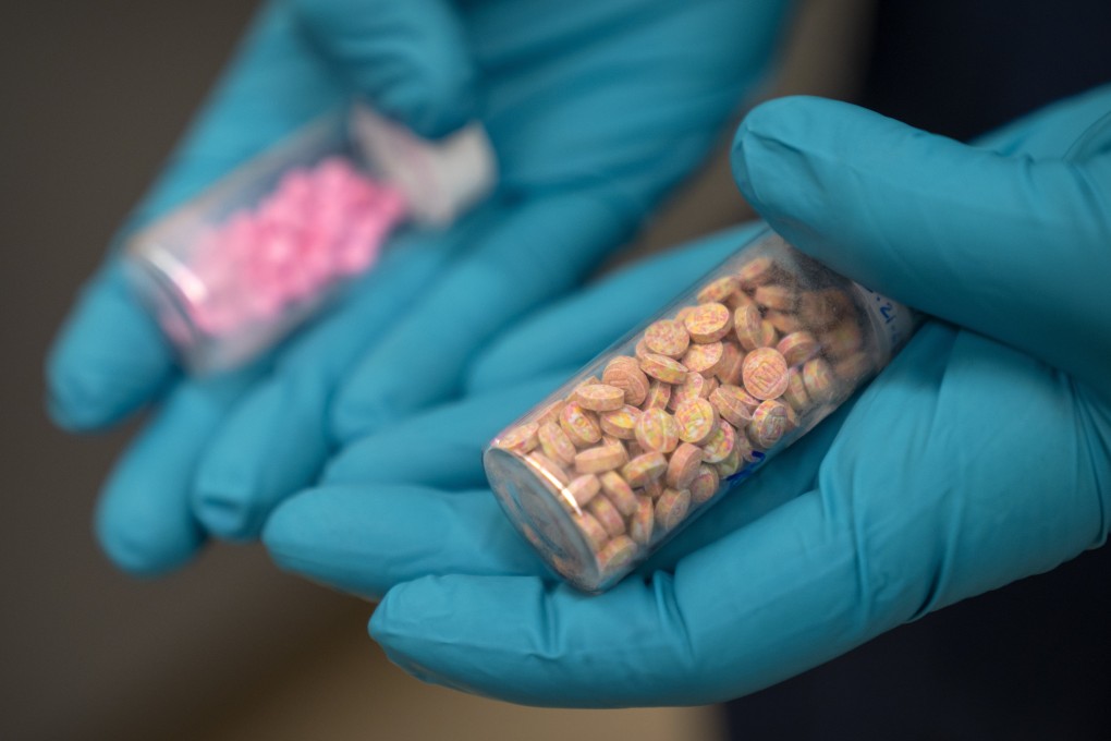 A US Drug Enforcement Administration chemist holds vials of fentanyl pills at a DEA research laboratory in Northern Virginia in . April. Photo: AP