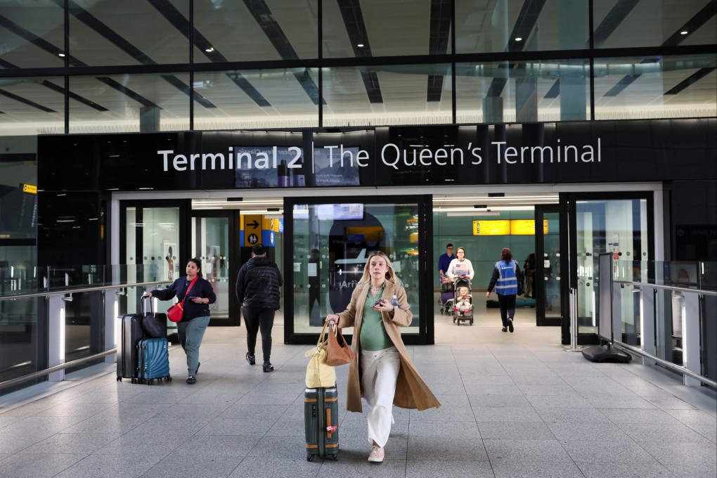 People walk at Terminal 2 of the Heathrow International Airport in March. Photo: Reuters