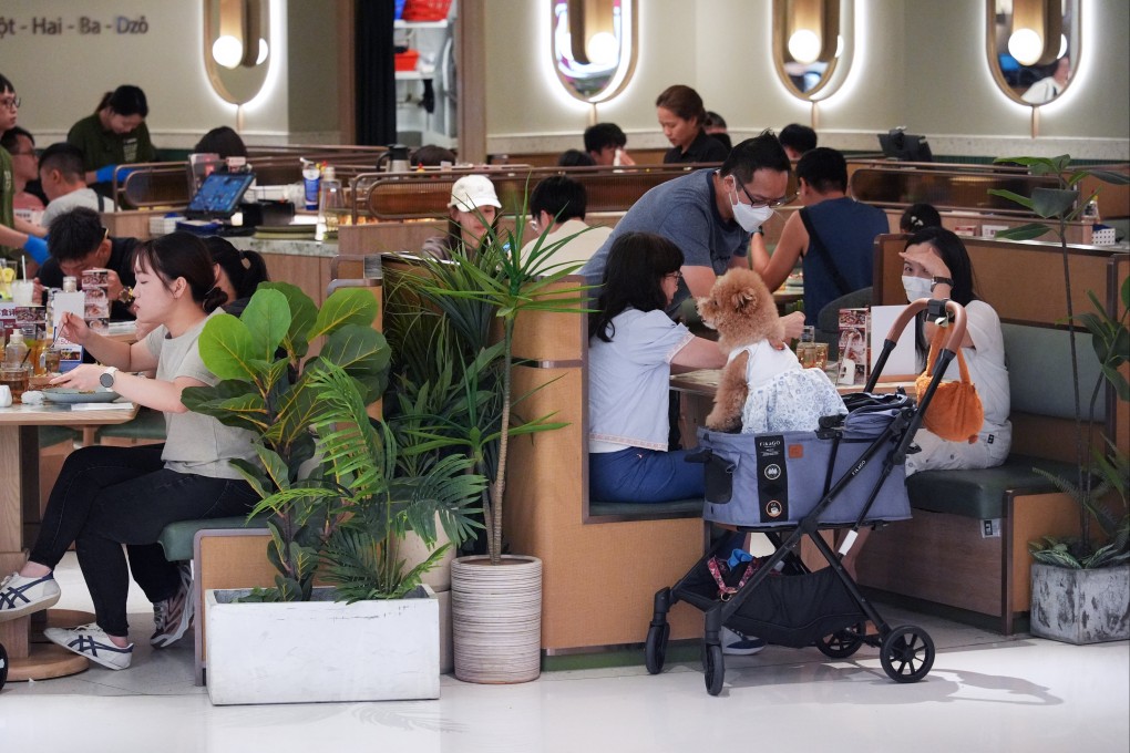 Diners bring a dog to a pet-friendly shopping centre in Sha Tin. Photo: Eugene Lee