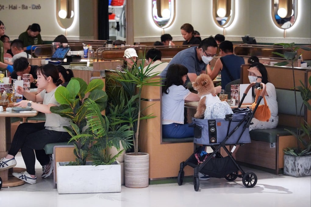 Diners bring a dog to a pet-friendly shopping centre in Sha Tin. Photo: Eugene Lee