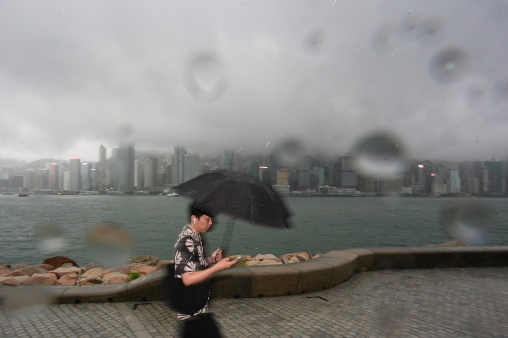 A man walks through the West Kowloon Cultural District in the rain on Saturday. Photo: Eugene Lee