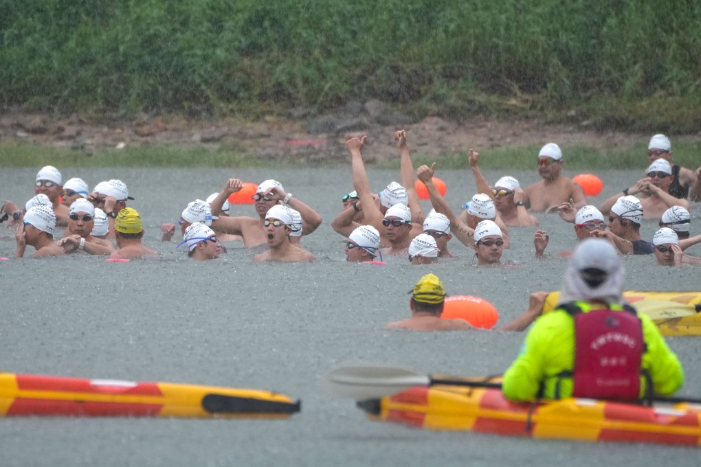 Swimmers participate in the Tolo Harbour race in the rain on Sunday. Photo: Sam Tsang