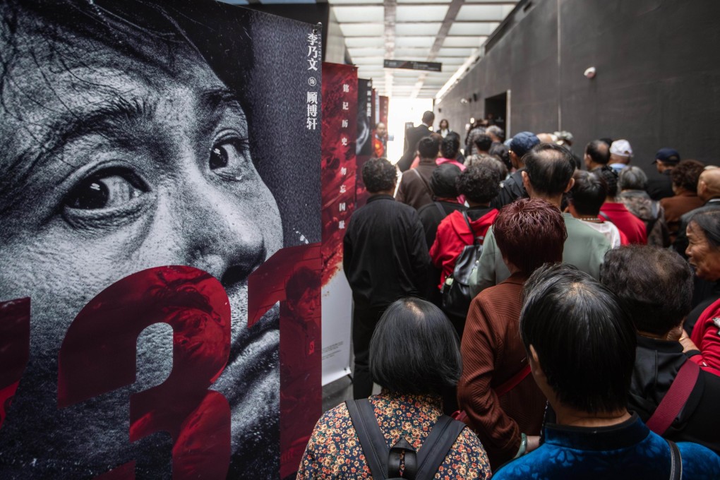 People walk past a poster of the film 731 in Harbin, Heilongjiang province, on Thursday. Photo: Xinhua
