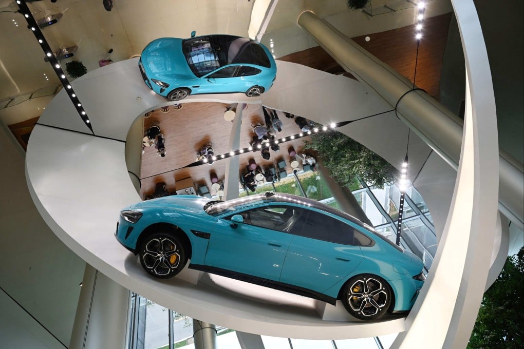 (FILES) A Xiaomi SU7 Max car is displayed at the entrance to the Xiaomi EV Factory, where all Xiaomi EV cars are made, in Beijing on July 1, 2025. Chinese consumer tech giant Xiaomi will remotely fix a flaw in the assisted driving system on over 110,000 of its popular SU7 electric cars, the firm and regulators said on September 19, 2025, months after a deadly crash involving the model. (Photo by GREG BAKER / AFP)