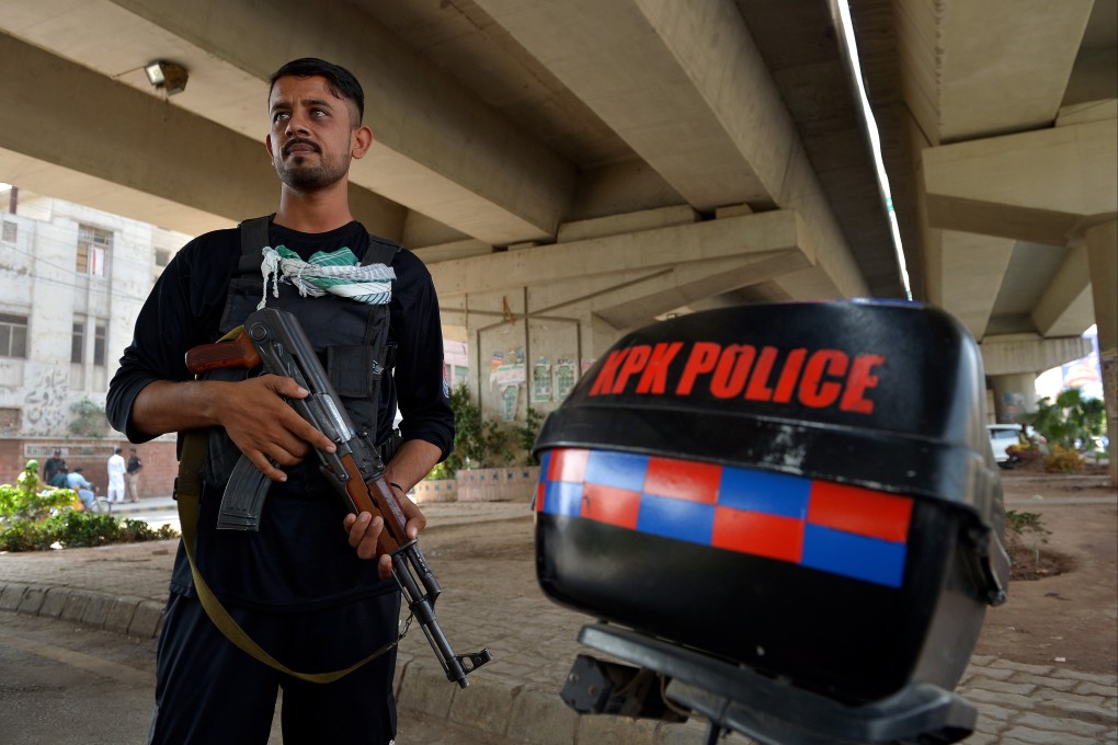 A Pakistani security official stands guard at a checkpoint, as security has been intensified, in Peshawar, Khyber Pakhtunkhwa province on Monday. Photo: EPA