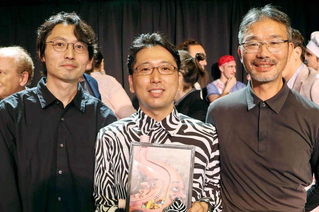 (From left) Kazato Oishi, Tomoki Kojima and Sei Sato, pose for photos in Boston on Thursday after their team won the Ig Nobel Prize in Biology. Their experiment showing that painting zebra-like stripes on cattle significantly reduces the number of biting flies landing on them was recognised at the ceremony in Boston. Photo: Kyodo