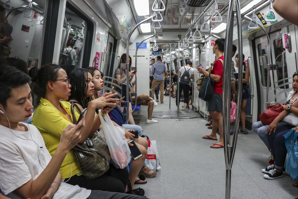 Commuters on an MRT train in Singapore. A string of service faults across several MRT and LRT lines in recent months disrupted travel in the city state. Photo: Roy Issa