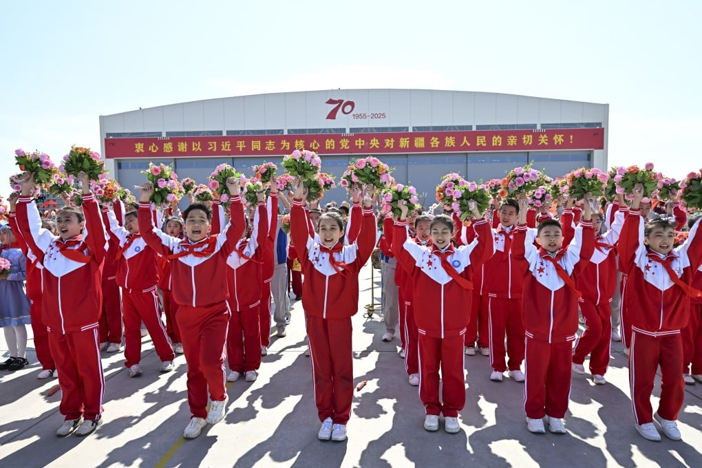 Children cheer as Chinese President Xi Jinping arrives in Urumqi Tianshan International Airport in Xinjiang on Tuesday. Photo: Xinhua