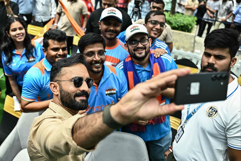 Dinesh Karthik takes a selfie with cricket fans during the unveiling of the ICC Women’s Cricket World Cup Trophy in Bengaluru on September 13, 2025. Photo: AFP