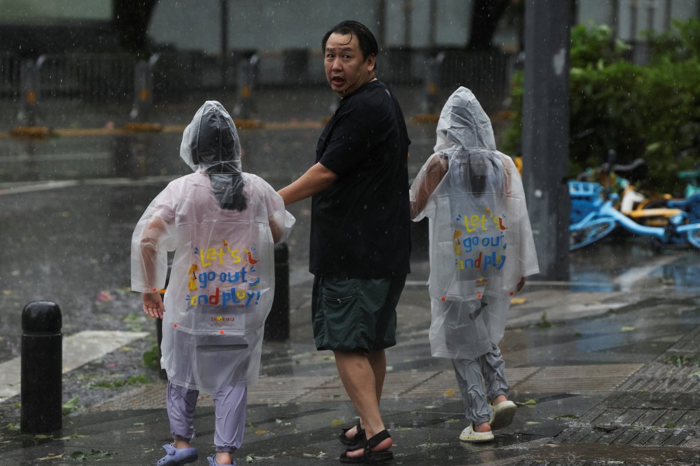 People brave strong wind and rain as Super Typhoon Ragasa approaches Shenzhen on Wednesday. Photo: Reuters