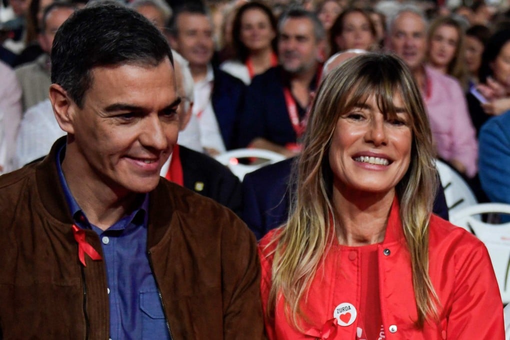 Spain’s Prime Minister Pedro Sánchez (left) holds hands with his wife Begoña Gómez at a political event in December. Photo: AFP