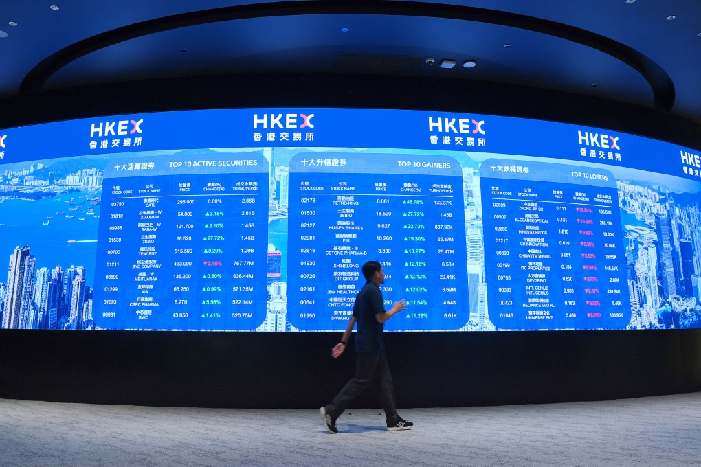 A man walks past an electronic display board at the Hong Kong Stock Exchange in Central on May 20. Photo: Xinhua