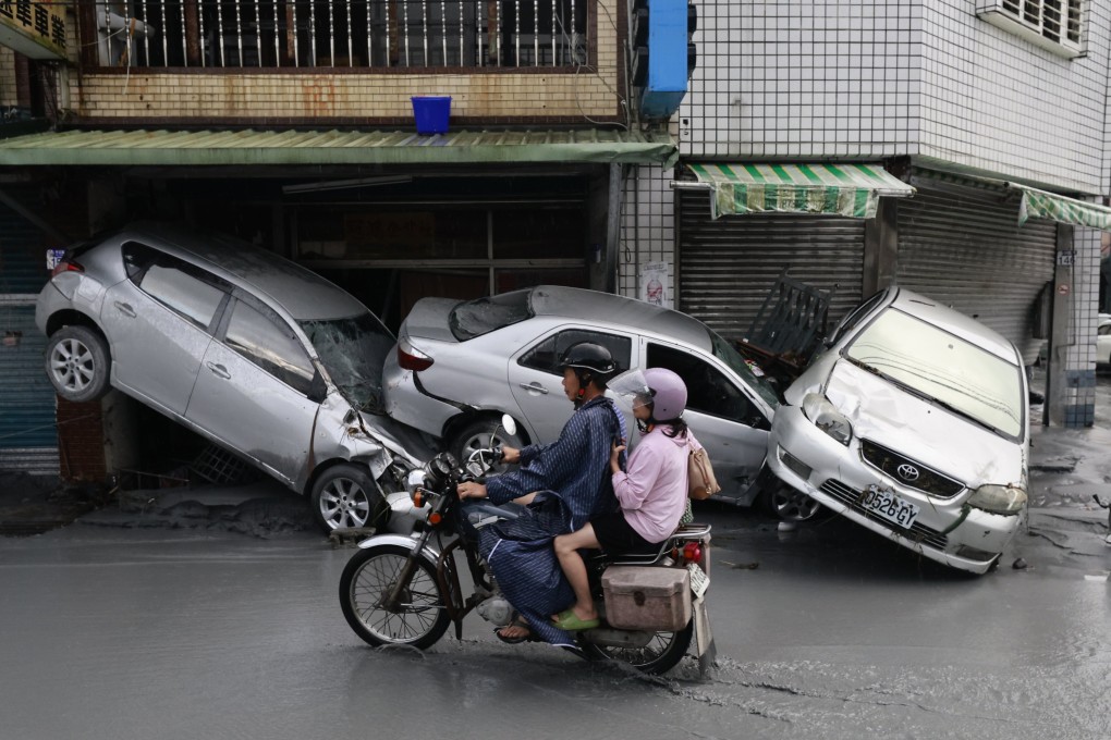 Motocyclists ride past damaged vehicles on a flooded street in the aftermath of Super Typhoon Ragasa in Guangfu Township, Taiwan, on Wednesday. Scientists warn that extreme weather events like Ragasa are increasing due to climate change. Photo: EPA