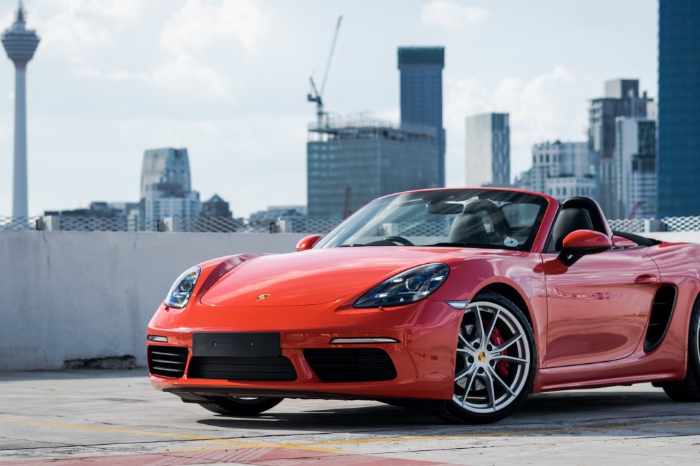 A red Porsche Cayman in a car park in Kuala Lumpur, Malaysia. Photo: Shutterstock