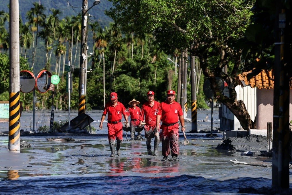 A rescue team looks for flood victims in Hualien on Thursday following torrential rain. The disaster has sparked political hostilities and accusations that fatalities could have been avoided. Photo: AFP
