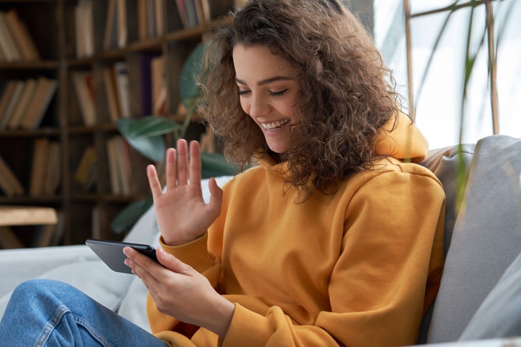 “Tech neck” describes the impact that hunching over when looking at technology has on the neck. Experts say better device positioning and using sunscreen can help prevent neck ageing. Photo: Shutterstock