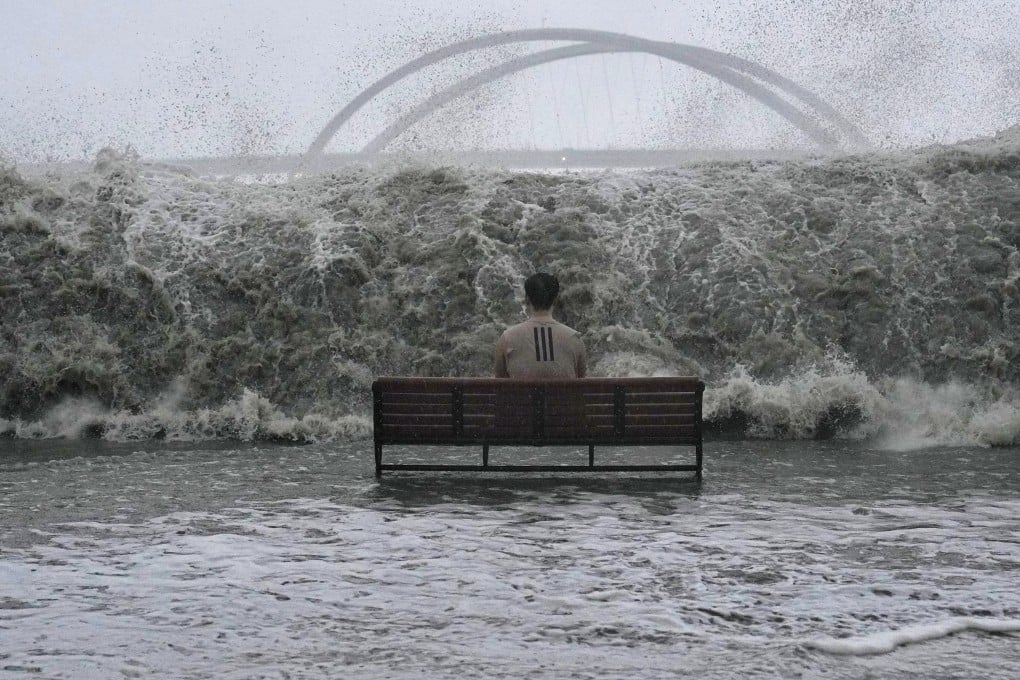 A man sits on a bench on the Tseung Kwan O promenade as the waves approach during Ragasa. Photo: Elson Li