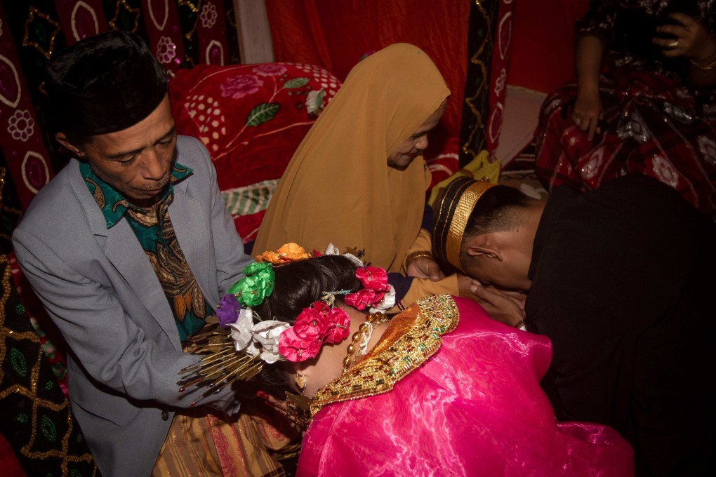 A couple in a village in Mamuju, West Sulawesi, Indonesia asking for their parents’ blessing. Photo: AFP