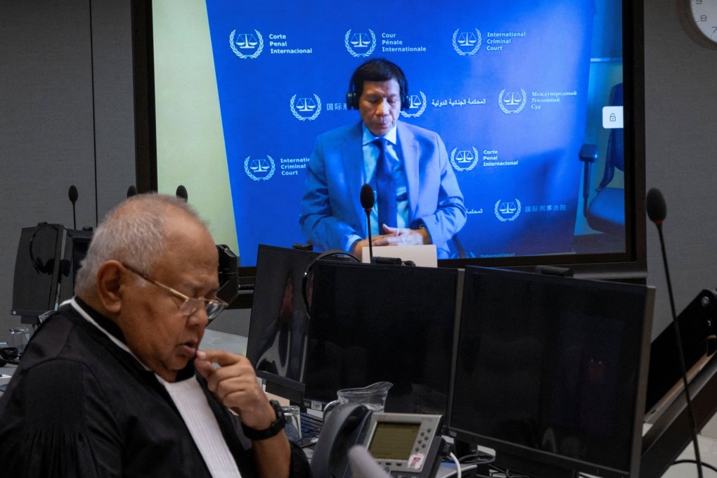 Former Philippine president Rodrigo Duterte is seen on a screen in the courtroom of the International Criminal Court (ICC) with his lawyer Salvador Medialdea seated left, in The Hague, Netherlands, on March 14. Photo: Reuters