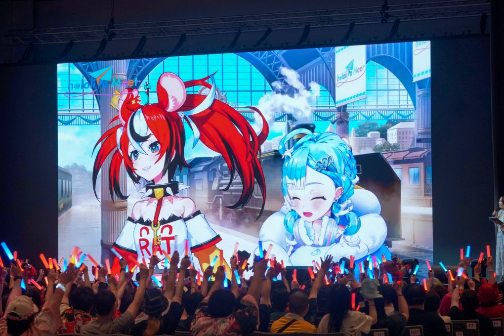 Fans wave glowsticks at a screen featuring VTubers Hakos Baelz (left) and Kobo Kanaeru at the Hopewell Hotel Grand Ballroom in Hong Kong, part of the “hololive Meet @ Hong Kong 2025 ft. Hakos Baelz and Kobo Kanaeru” event, on July 27, 2025. Photo: Cover via InfiniteOne