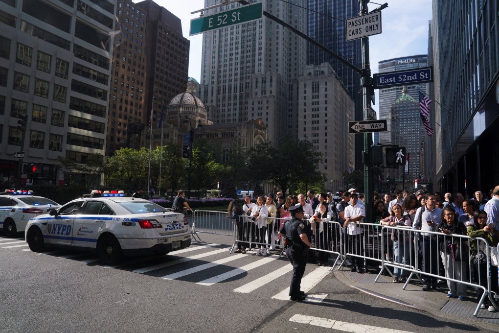 Pedestrians wait as the presidential motorcade of US President Donald Trump drives by during the 80th United Nations General Assembly in New York City on Tuesday. Photo: Reuters