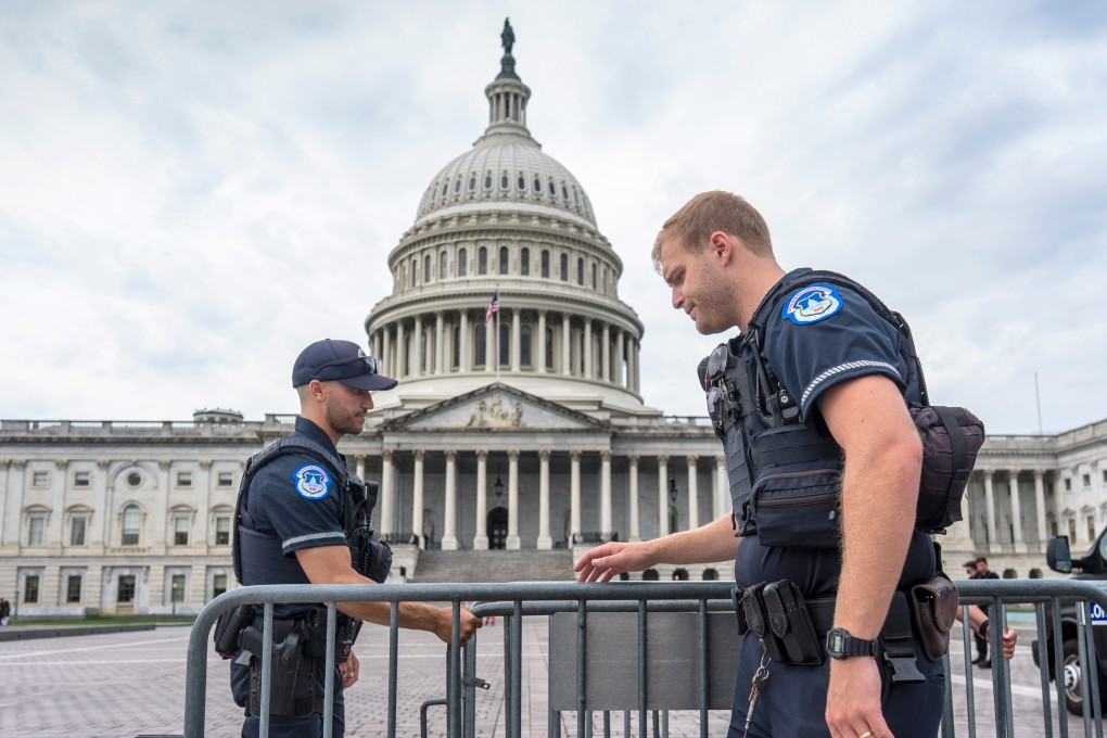 Capitol Police officers adjust security barriers around the East Plaza on Wednesday. Photo: AP