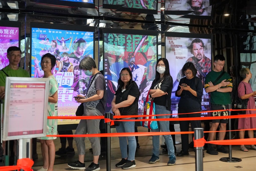 People queue up at a cinema in Tseung Kwan O to try and get their hands on half-priced tickets. Photo: May Tse