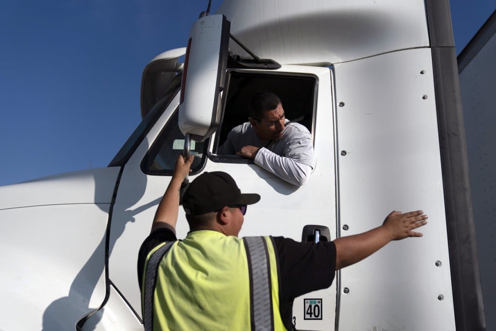 An instructor talks to a student driver at a driving academy in California. Photo: AP