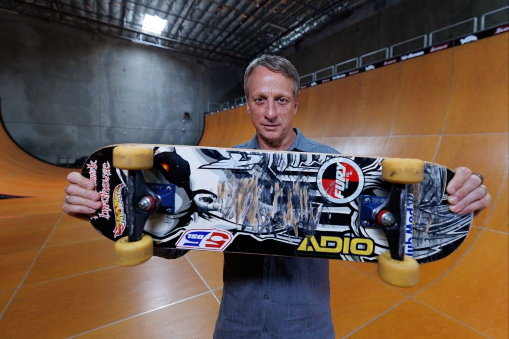 Tony Hawk holds the skateboard he used to land the first “900” at the 1999 X Games, a milestone that transformed skateboarding from subculture to global sport and made Hawk its defining icon. Photo: Reuters
