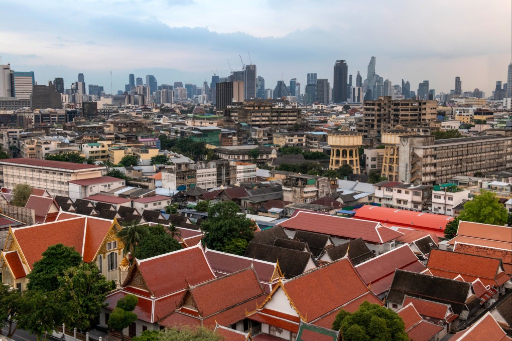 Commercial high-rise buildings are pictured behind the Wat Saket temple complex in Bangkok on October 28, 2024. Photo: AFP