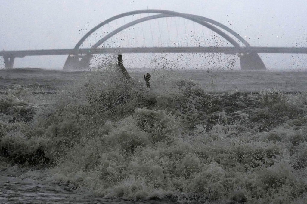 A man sitting on a bench at Tseung Kwan O Promenade was hit by swells during Super Typhoon Ragasa in Hong Kong on September 24. Photo: Elson Li