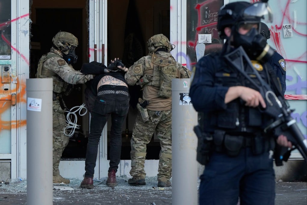 US Customs and Border Protection agents detain a man outside the Immigration and Customs building during a protest in Portland, Oregon, on June 14. Photo: AP