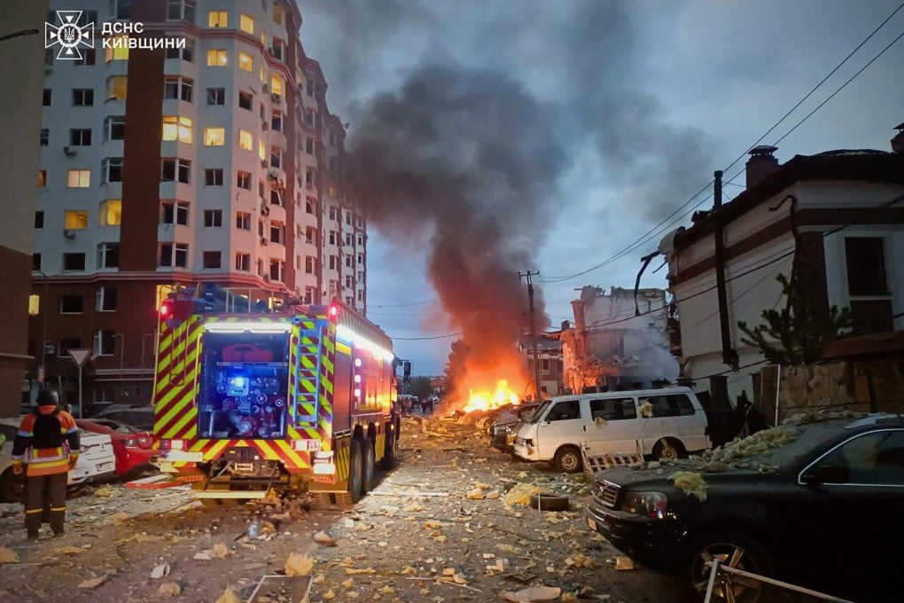 Ukrainian law enforcement officers work at the site of an air attack in the Kyiv region on Sunday. Photo: Ukrainian Emergency Service/AFP