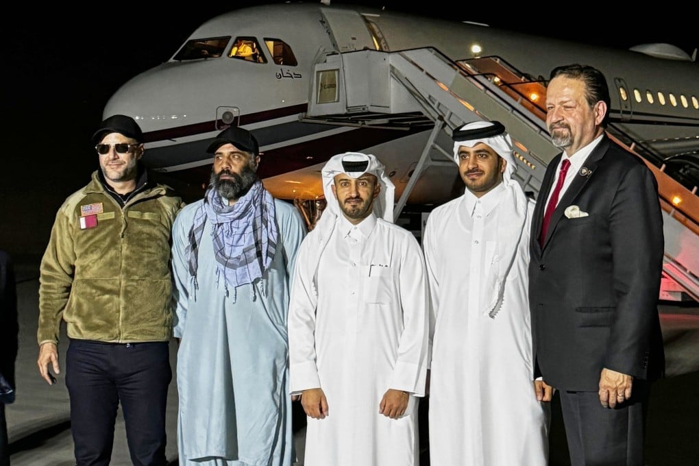 US citizen Amir Amiri, second from left, poses before boarding a plane in Kabul, Afghanistan, on Sunday after being released from an Afghan prison. With him, from right, is Deputy Assistant to the US President Sebastian Gorka, an unidentified Qatari diplomat, Charge d’Affaires of the Qatari embassy in Afghanistan Dr Mirdef al-Qashouti, centre, and, US Special Envoy for Hostage Response Adam Boehler. Photo: Qatar Foreign Ministry via AP